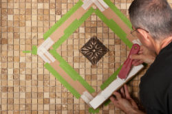 Man tiling backsplash