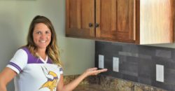 woman in front of Aspect stone backsplash